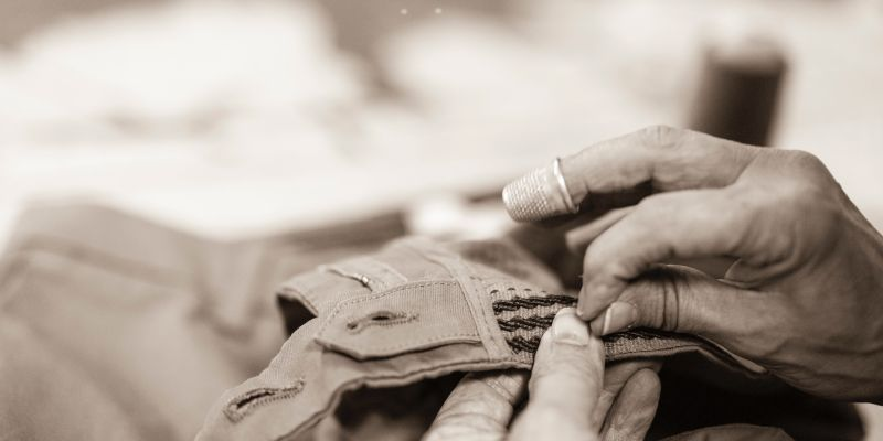 Artisan hands carefully crafting textile details, showcasing meticulous attention to quality